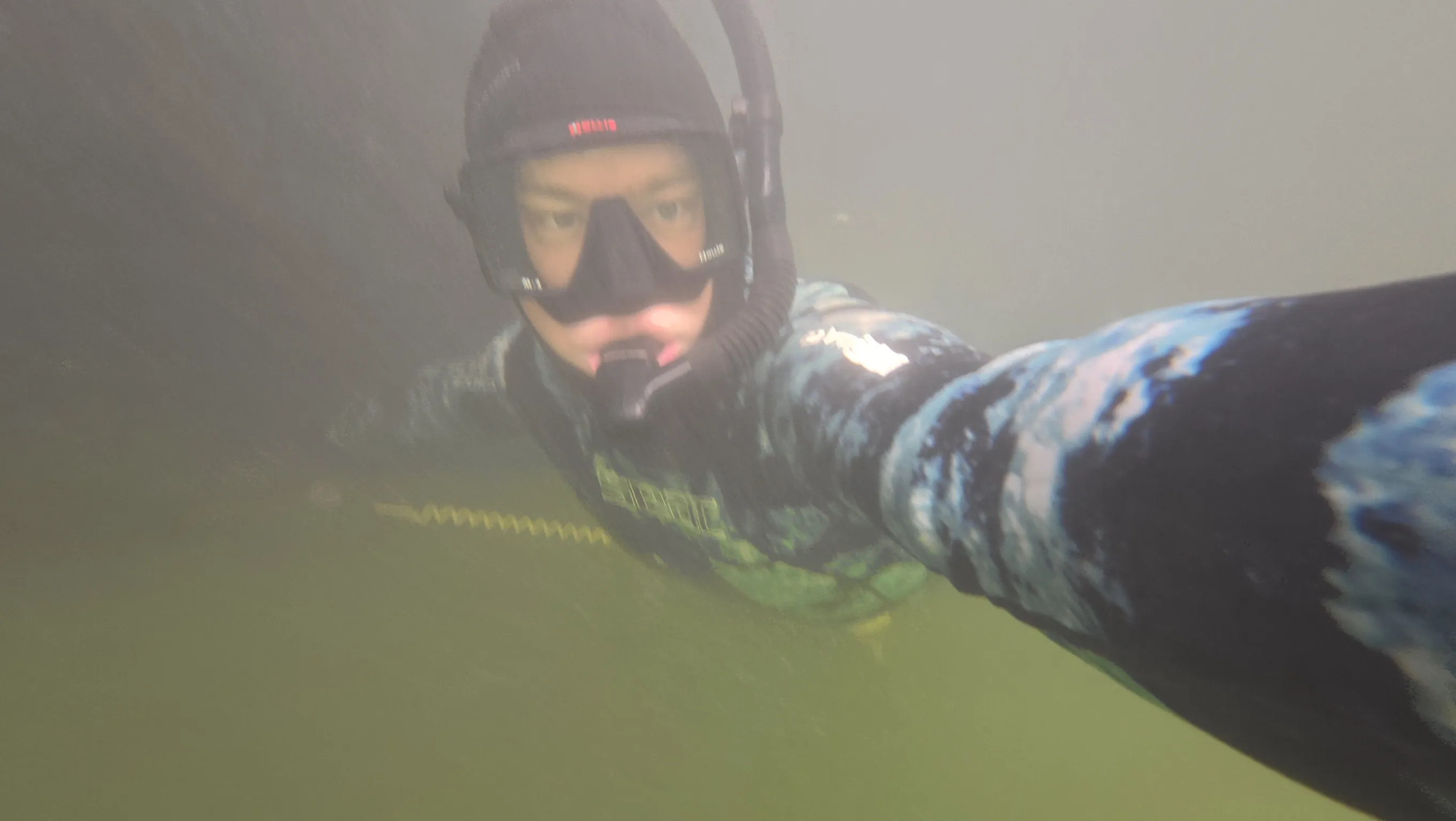 Diver performing boat hull maintenance in Jupiter, Florida
