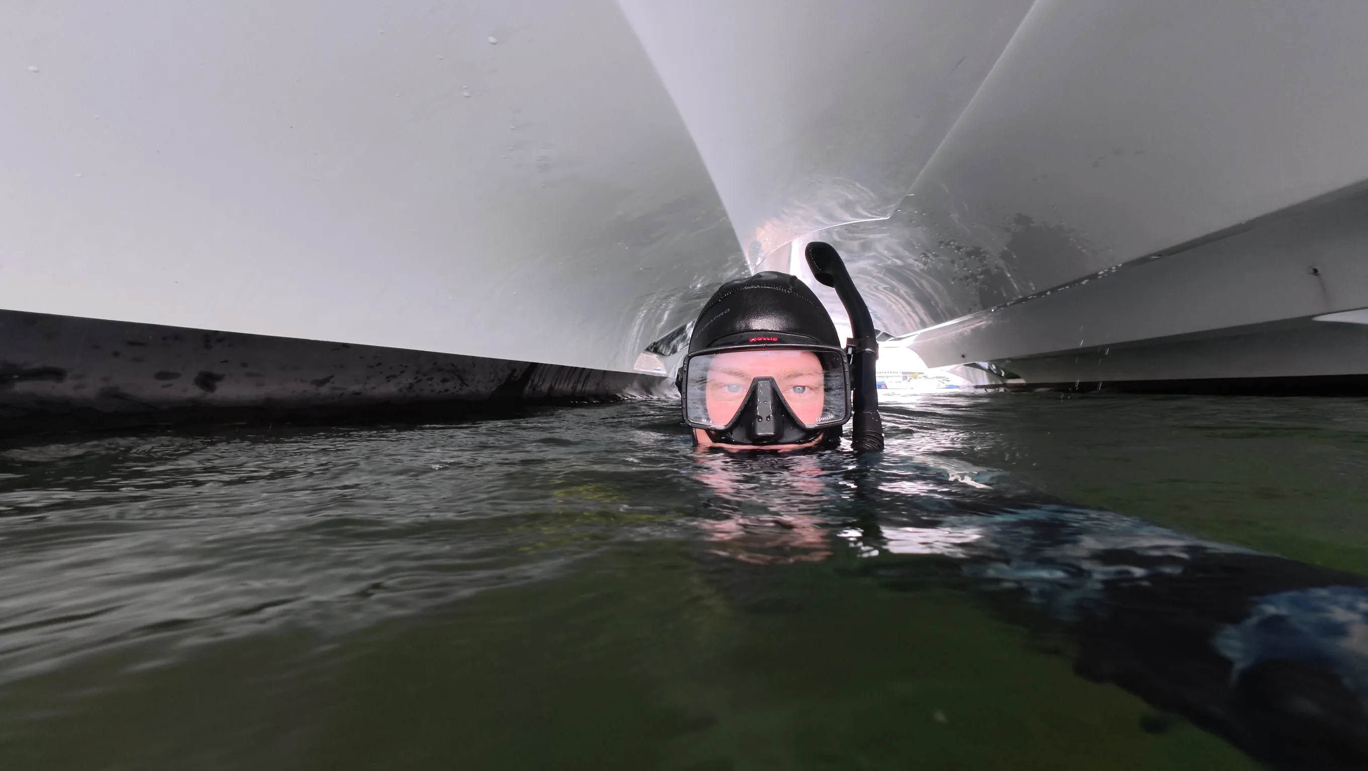 Diver cleaning a boat hull underwater near Riviera Beach, FL