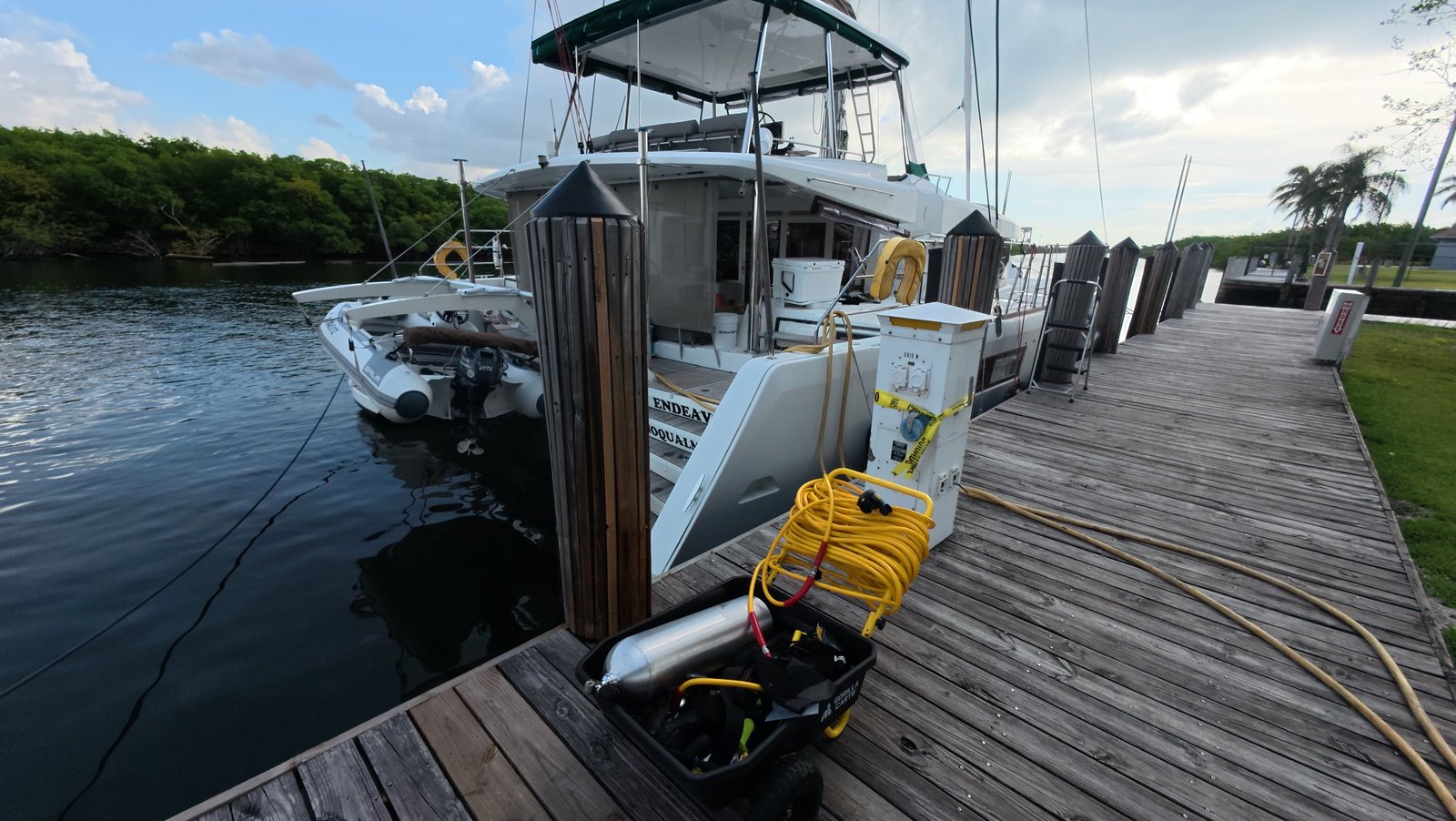 Certified diver scrubbing a boat hull underwater in Miami, FL