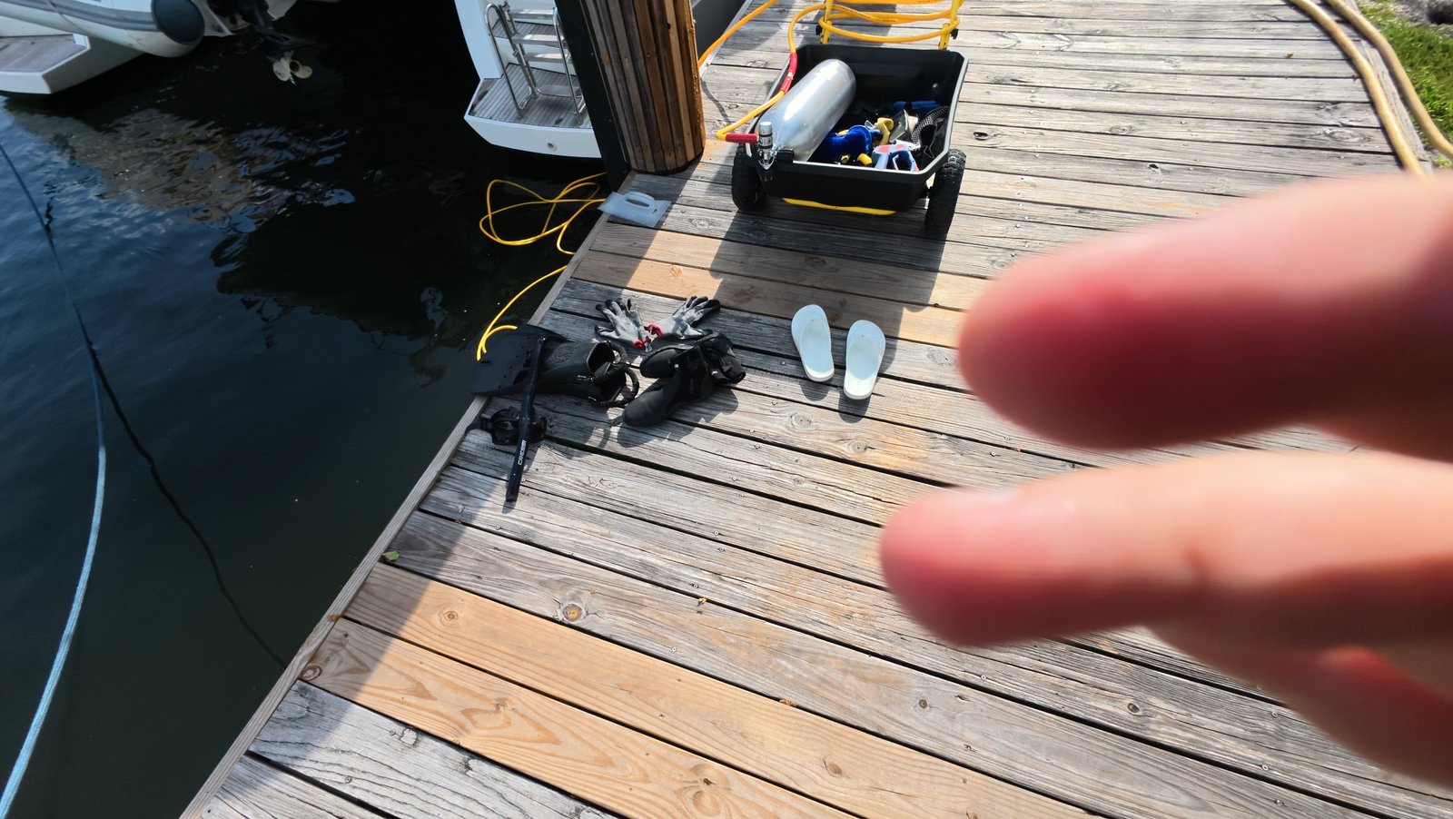 Diver checking boat propeller condition in an Aventura canal, Florida