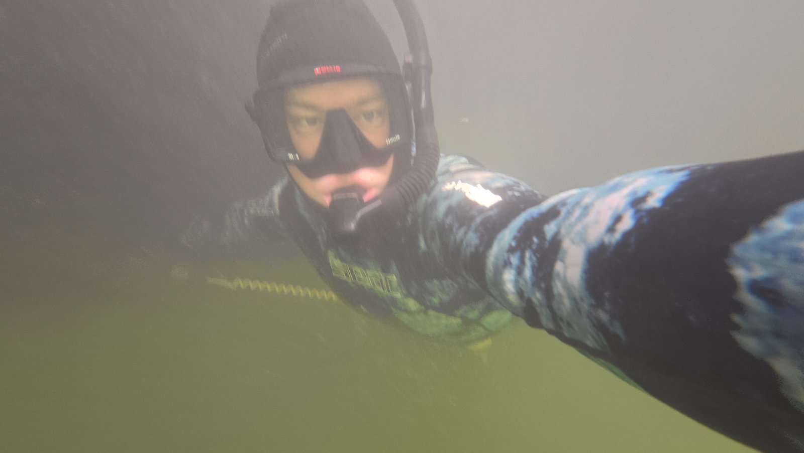 Diver performing boat hull maintenance in Jupiter, Florida