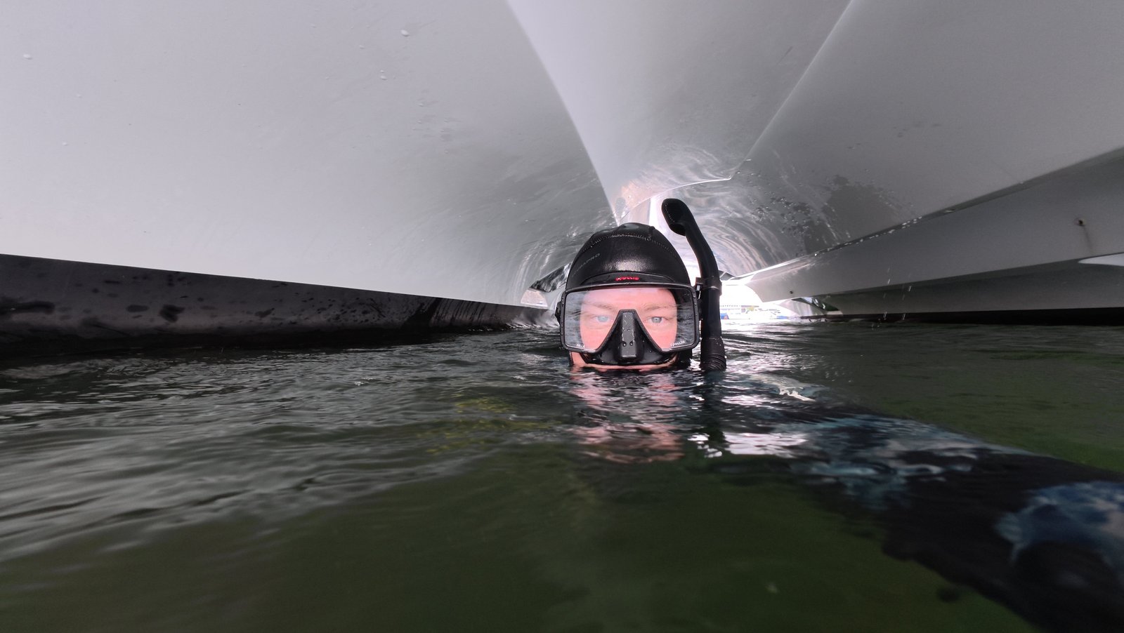 Diver cleaning a boat hull underwater near Riviera Beach, FL
